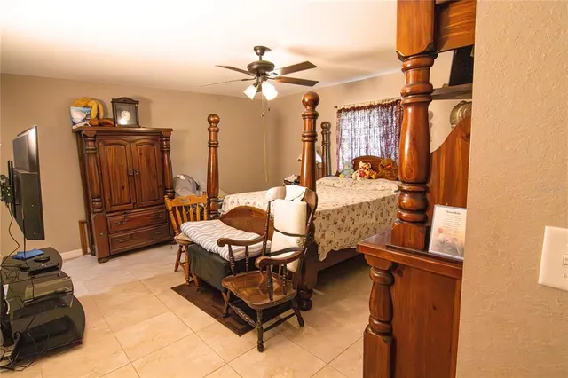 a bedroom with furniture and a chandelier
