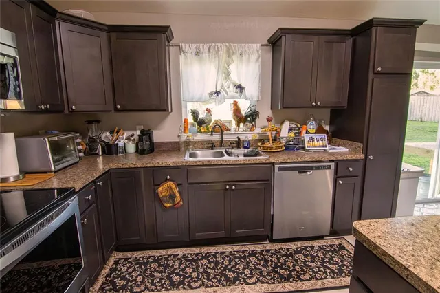 a kitchen with sink and cabinets