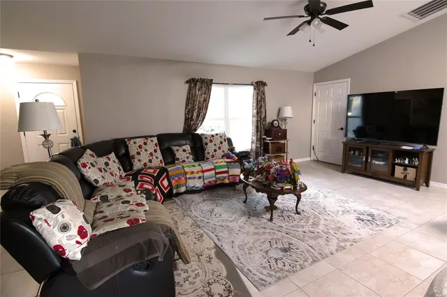 a bedroom with furniture and a flat screen tv