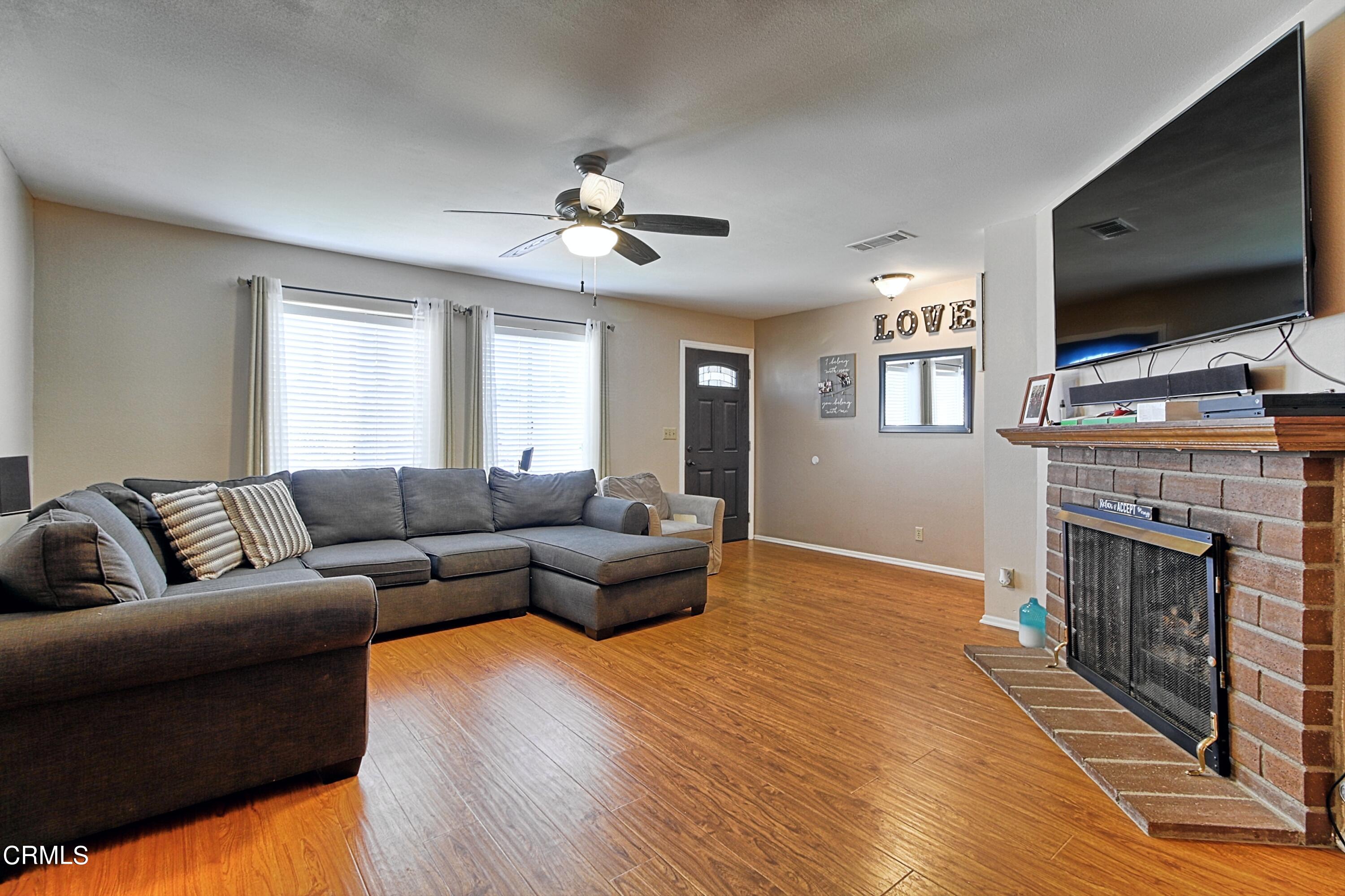 1801 Masthead Drive Oxnard, CA 93035 - Photo 13 of 27 a living room with fireplace furniture and a flat screen tv