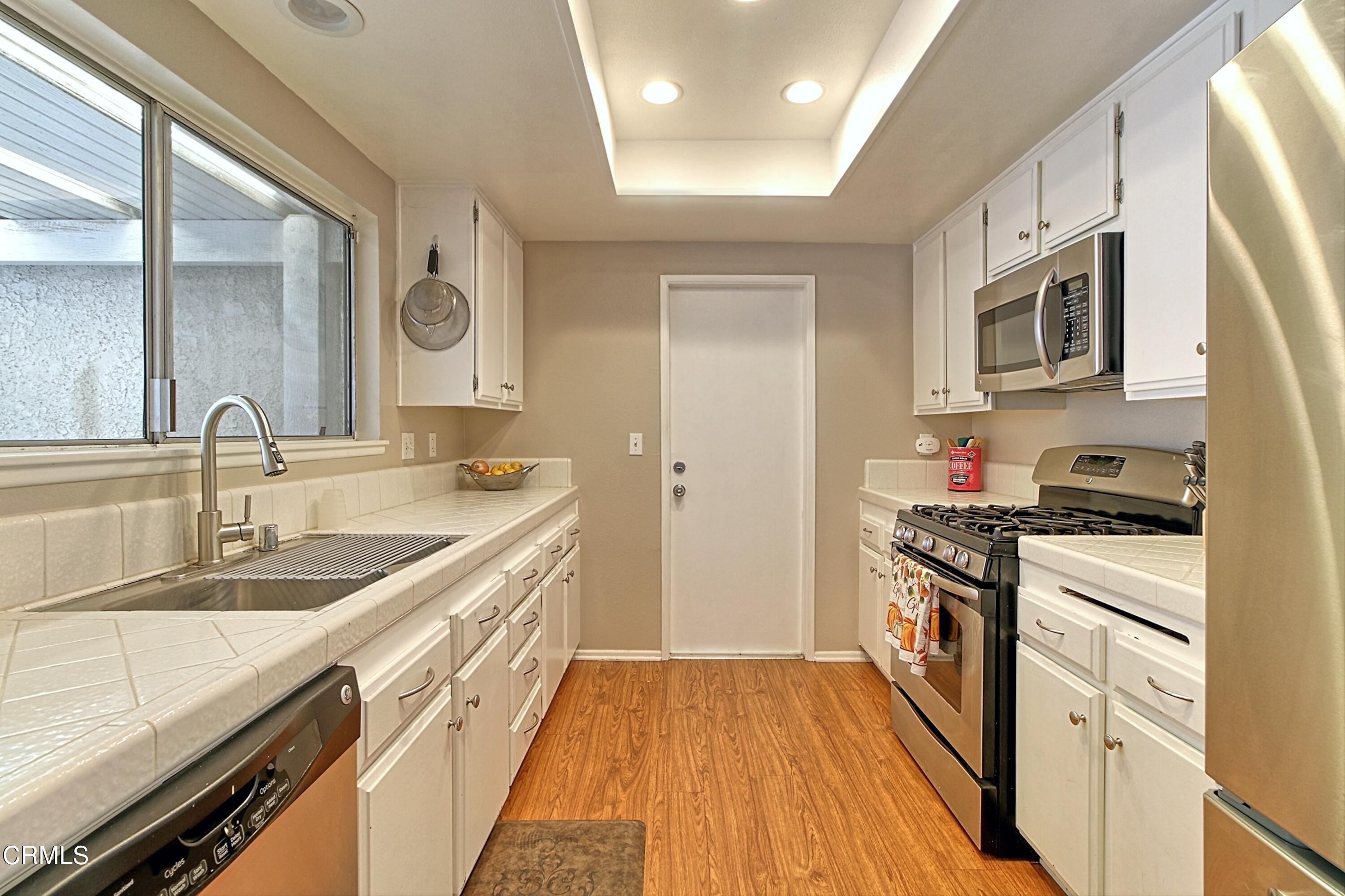 1801 Masthead Drive Oxnard, CA 93035 - Photo 18 of 27 a kitchen with stainless steel appliances granite countertop a sink stove and refrigerator
