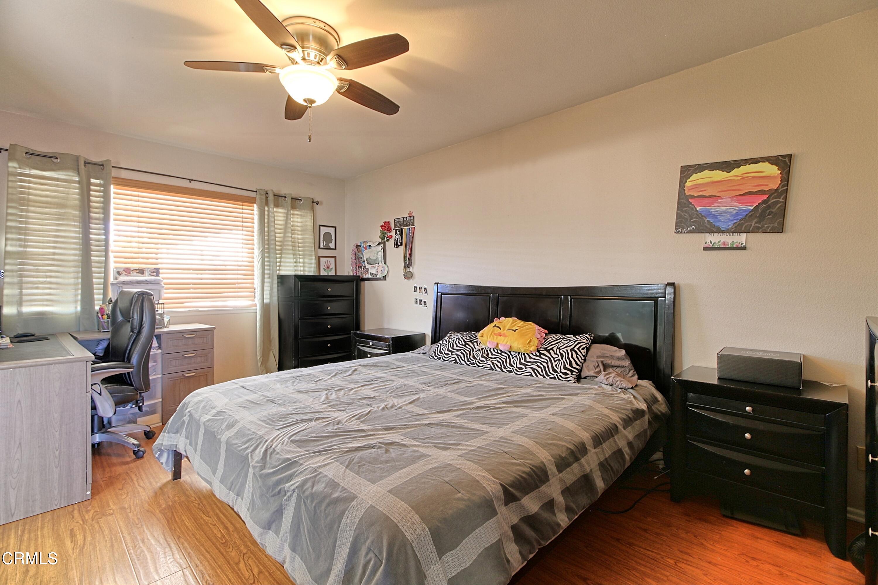 1801 Masthead Drive Oxnard, CA 93035 - Photo 22 of 27 a bedroom with a bed and wooden floor