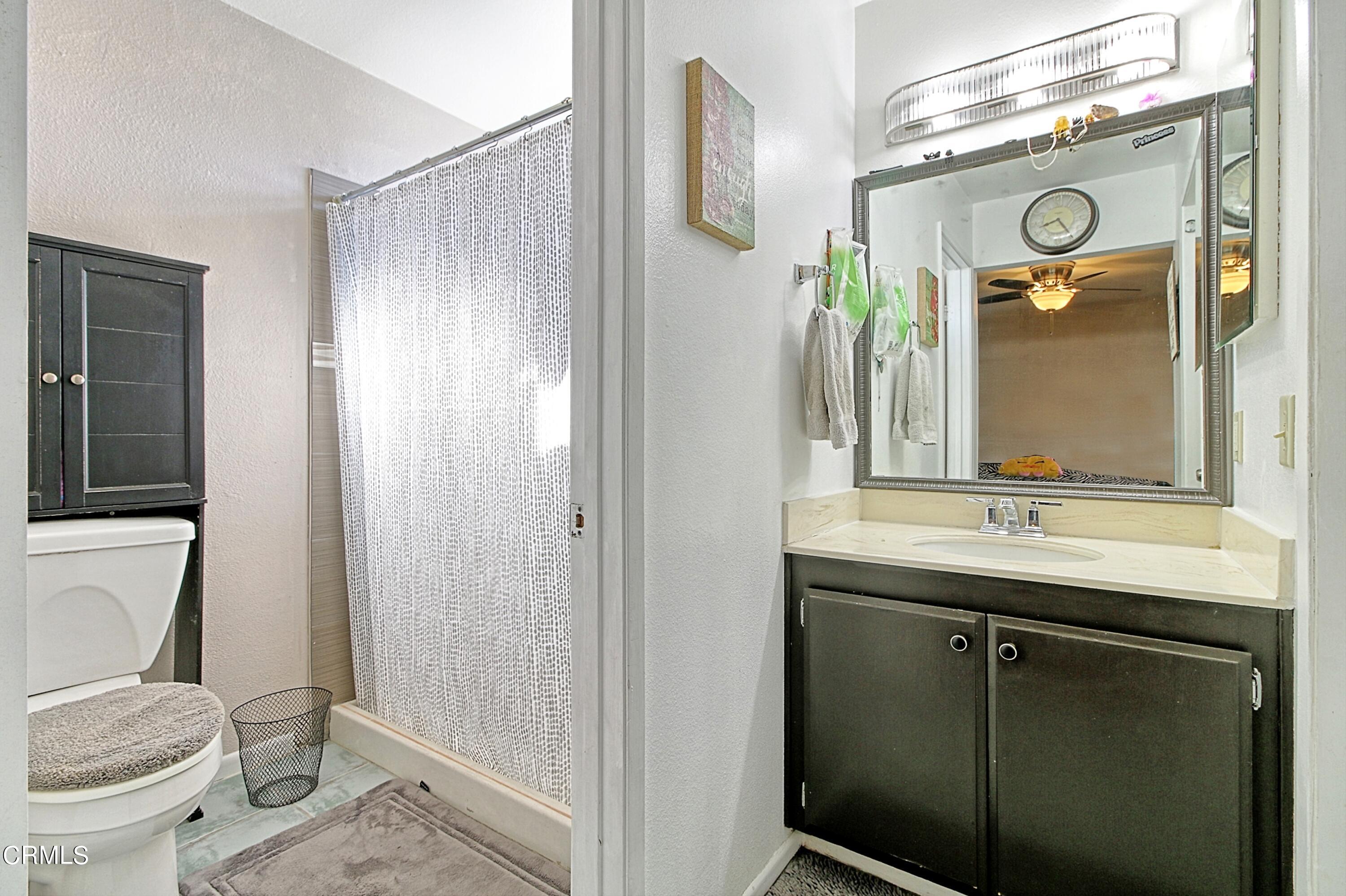 1801 Masthead Drive Oxnard, CA 93035 - Photo 24 of 27 a bathroom with a granite countertop sink a toilet and a mirror