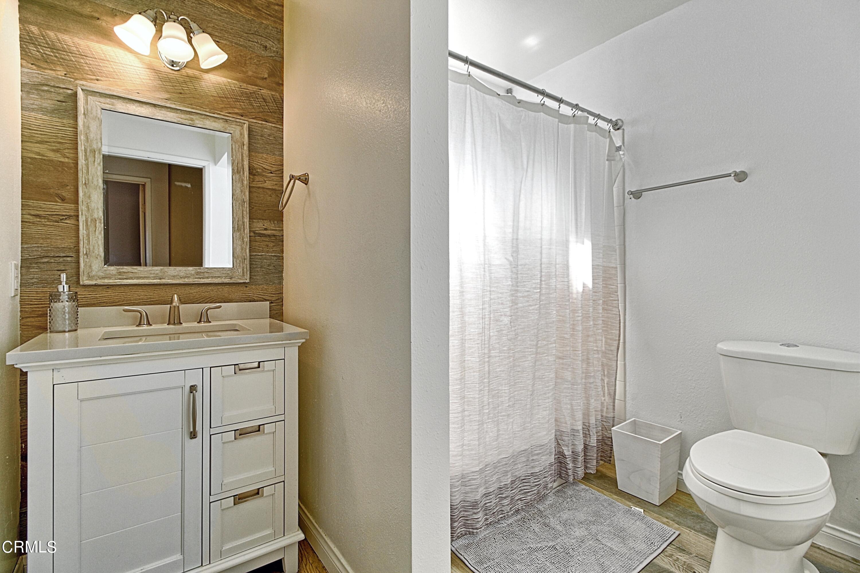1801 Masthead Drive Oxnard, CA 93035 - Photo 25 of 27 a bathroom with a granite countertop sink toilet and shower