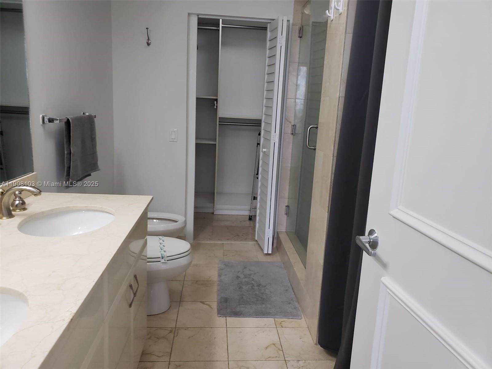 6365 Collins Avenue, Unit 1511 Miami Beach, FL 33141 - Photo 12 of 15 a bathroom with a sink toilet and shower