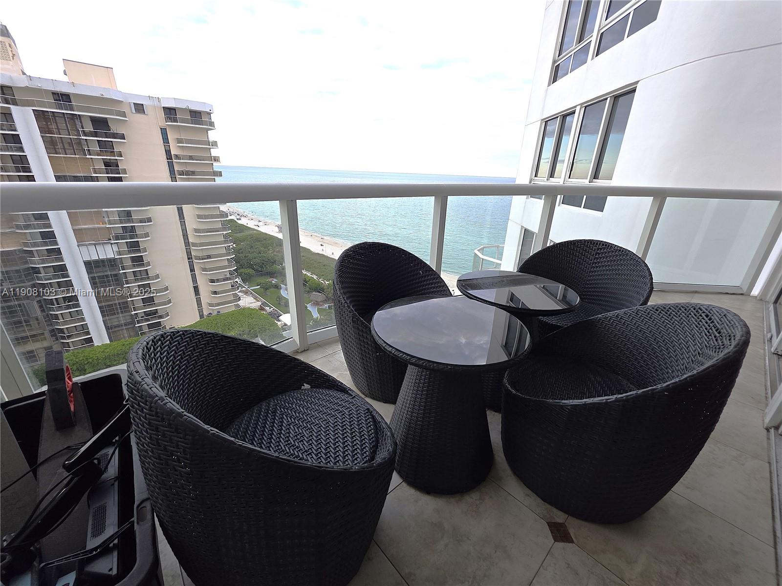 6365 Collins Avenue, Unit 1511 Miami Beach, FL 33141 - Photo 13 of 15 a living room with furniture and a window