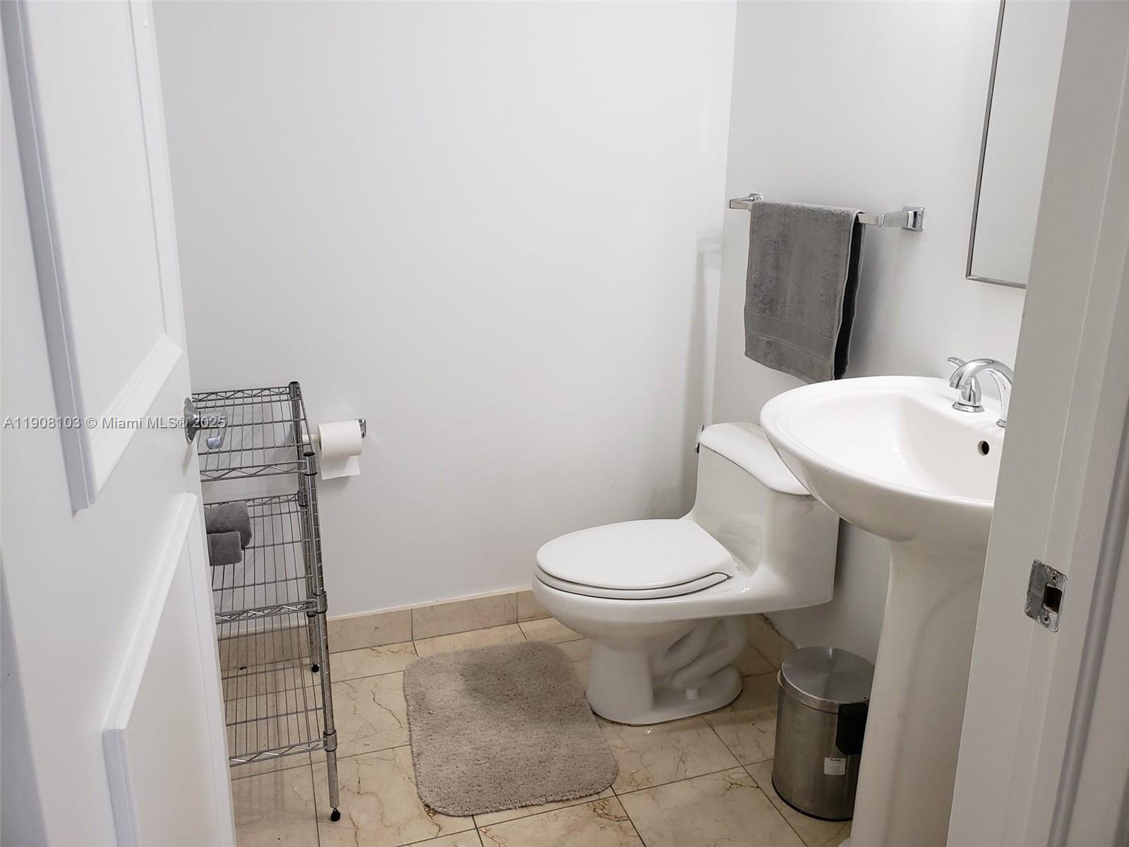 6365 Collins Avenue, Unit 1511 Miami Beach, FL 33141 - Photo 9 of 15 a bathroom with a toilet and a sink