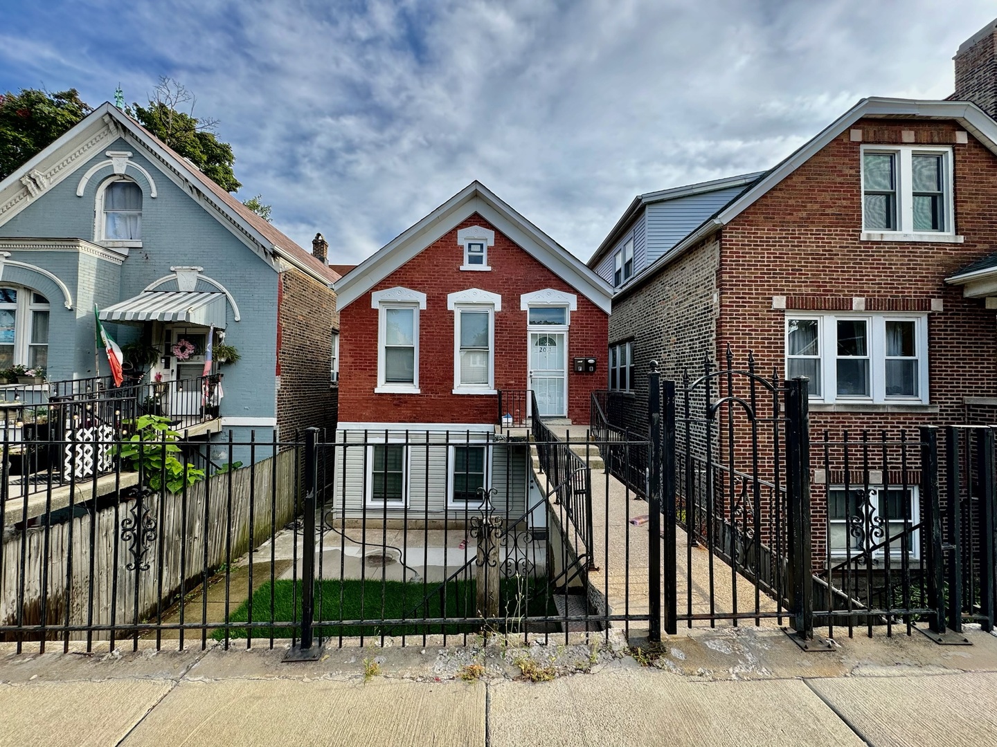 2011 West 22nd Place, Unit 1 Chicago, IL 60608 - Photo 1 of 13 a front view of a house with a yard