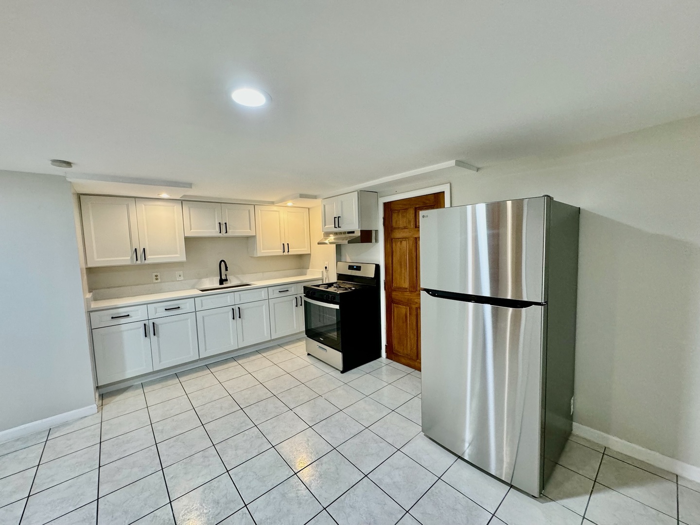 2011 West 22nd Place, Unit 1 Chicago, IL 60608 - Photo 7 of 13 a kitchen with a refrigerator sink and cabinets