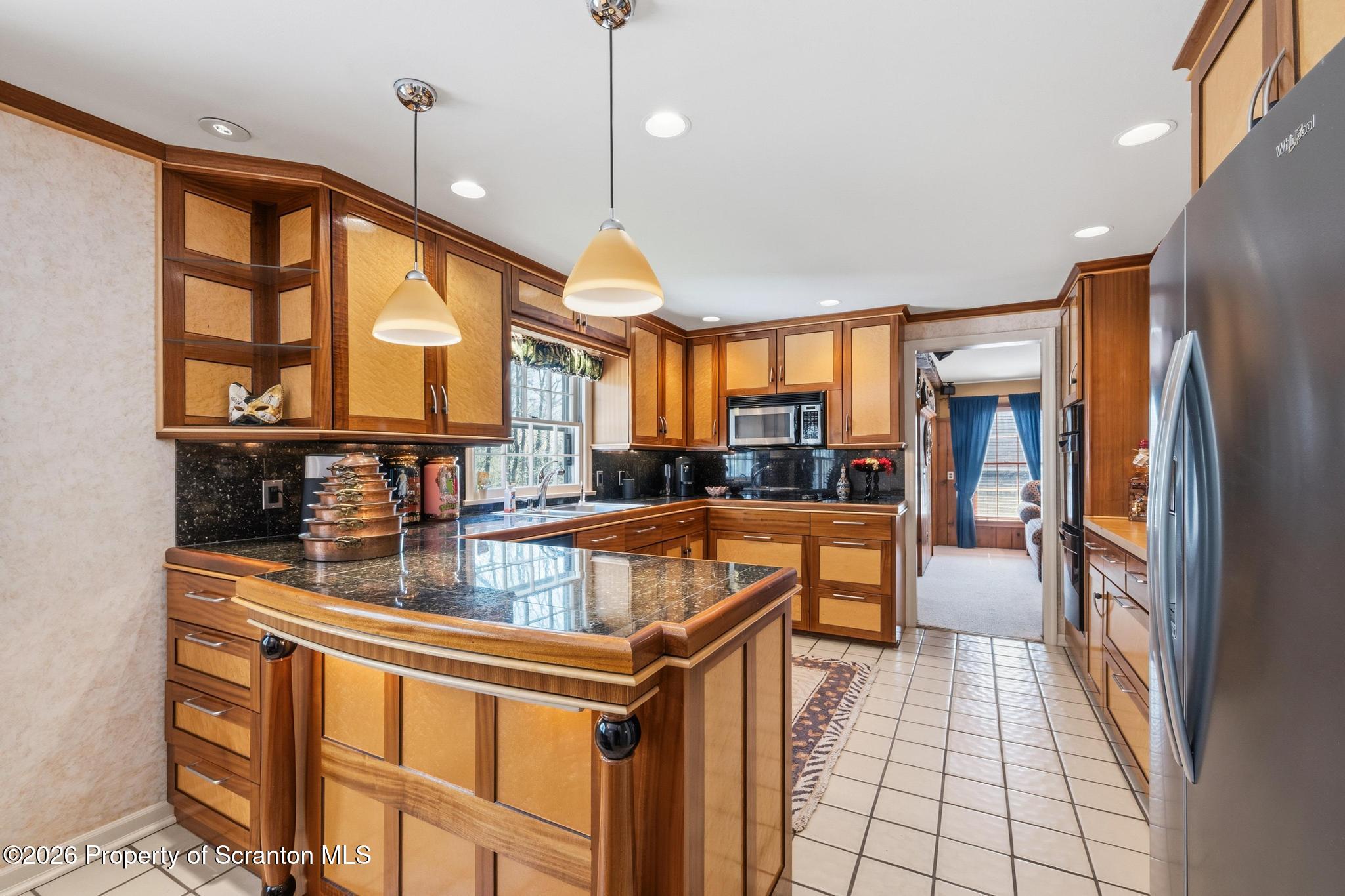 202 Woodlea Road Glenburn, PA 18414 - Photo 11 of 28 a kitchen with stainless steel appliances granite countertop a refrigerator and a sink