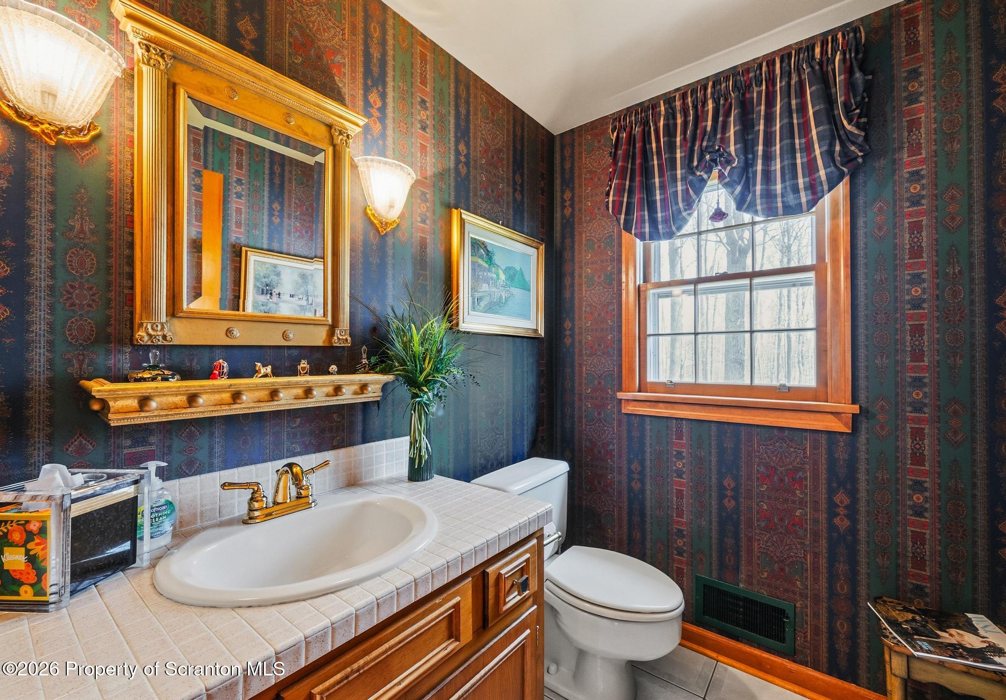 202 Woodlea Road Glenburn, PA 18414 - Photo 14 of 28 a bathroom with a sink toilet mirror vanity and shower