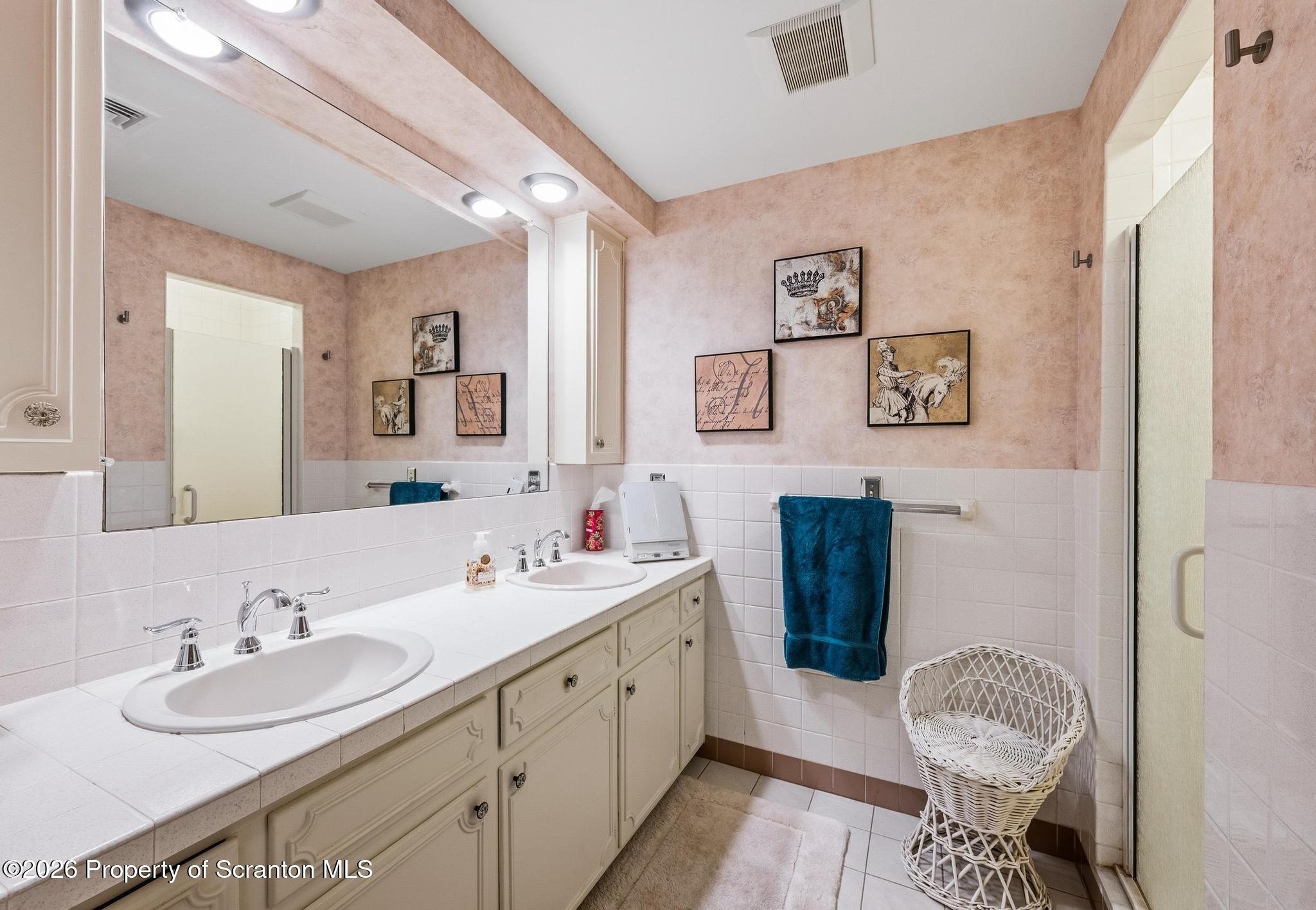 202 Woodlea Road Glenburn, PA 18414 - Photo 17 of 28 a bathroom with a double vanity sink mirror and toilet