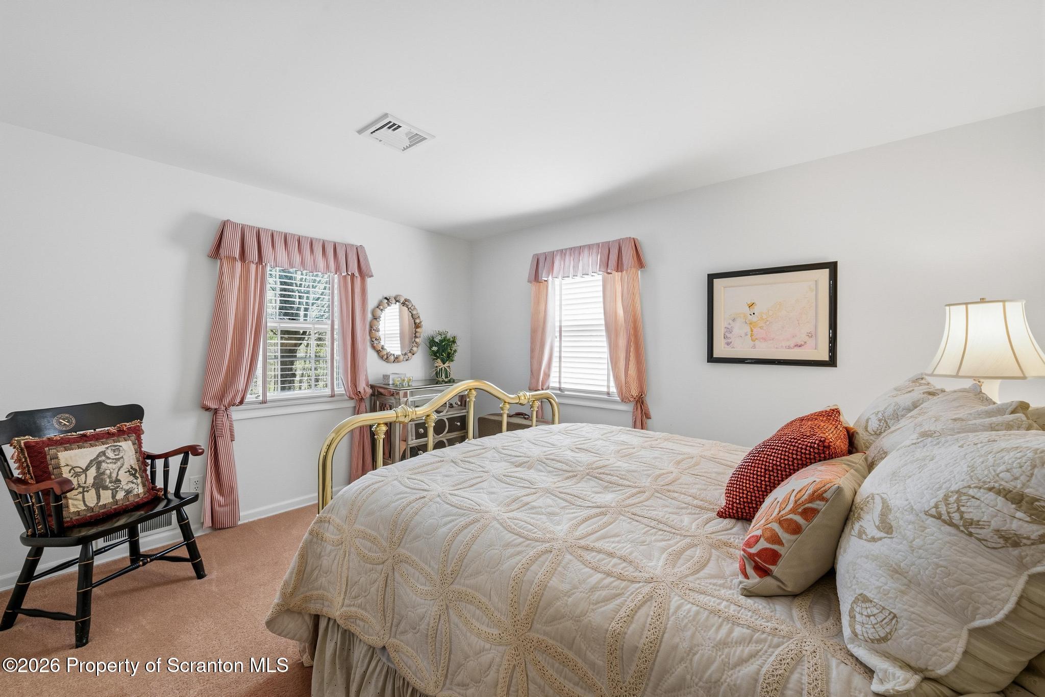 202 Woodlea Road Glenburn, PA 18414 - Photo 18 of 28 a bedroom with a bed and a desk