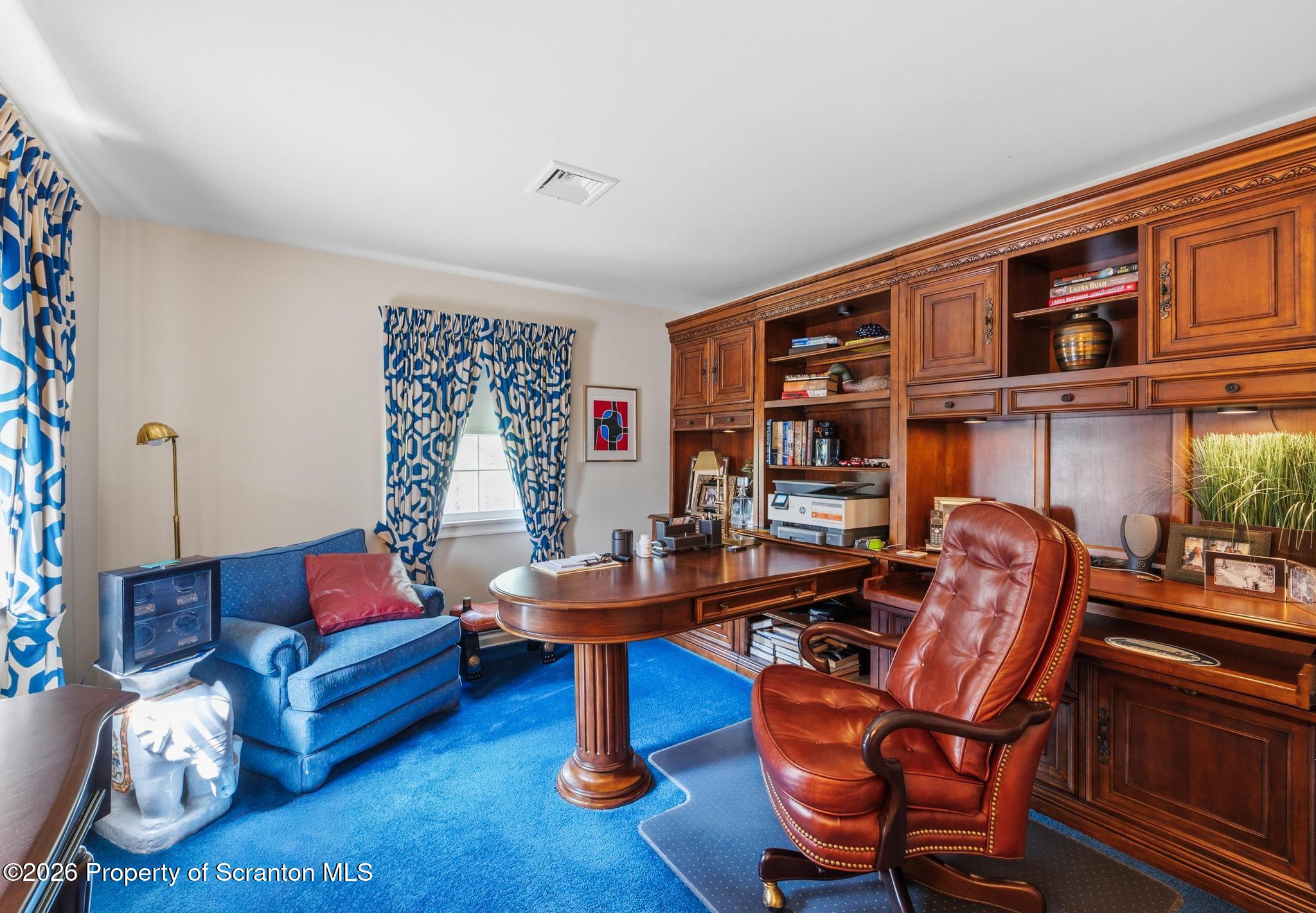 202 Woodlea Road Glenburn, PA 18414 - Photo 21 of 28 a living room with furniture and a book shelf