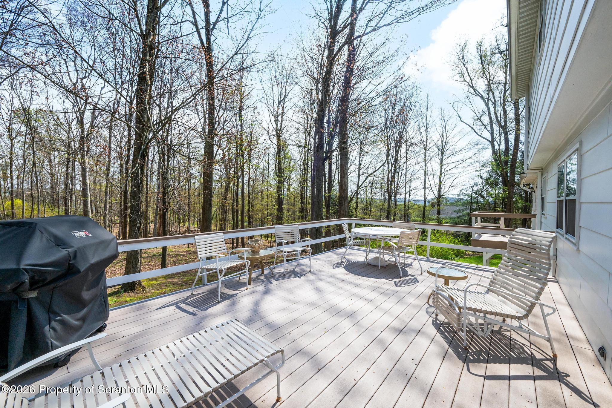 202 Woodlea Road Glenburn, PA 18414 - Photo 22 of 28 a view of a chair and tables in the patio
