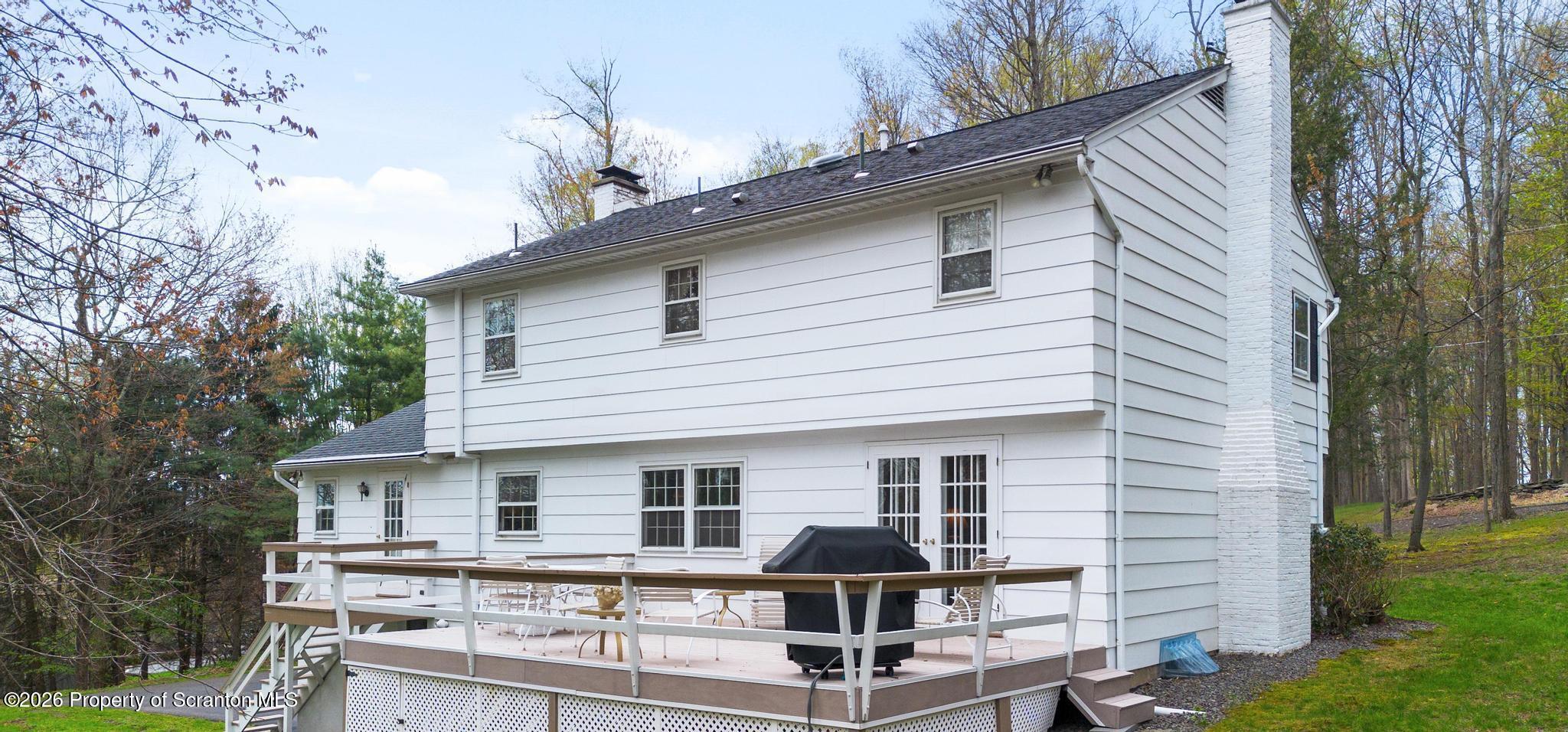 202 Woodlea Road Glenburn, PA 18414 - Photo 23 of 28 a front view of house with yard outdoor seating and garage