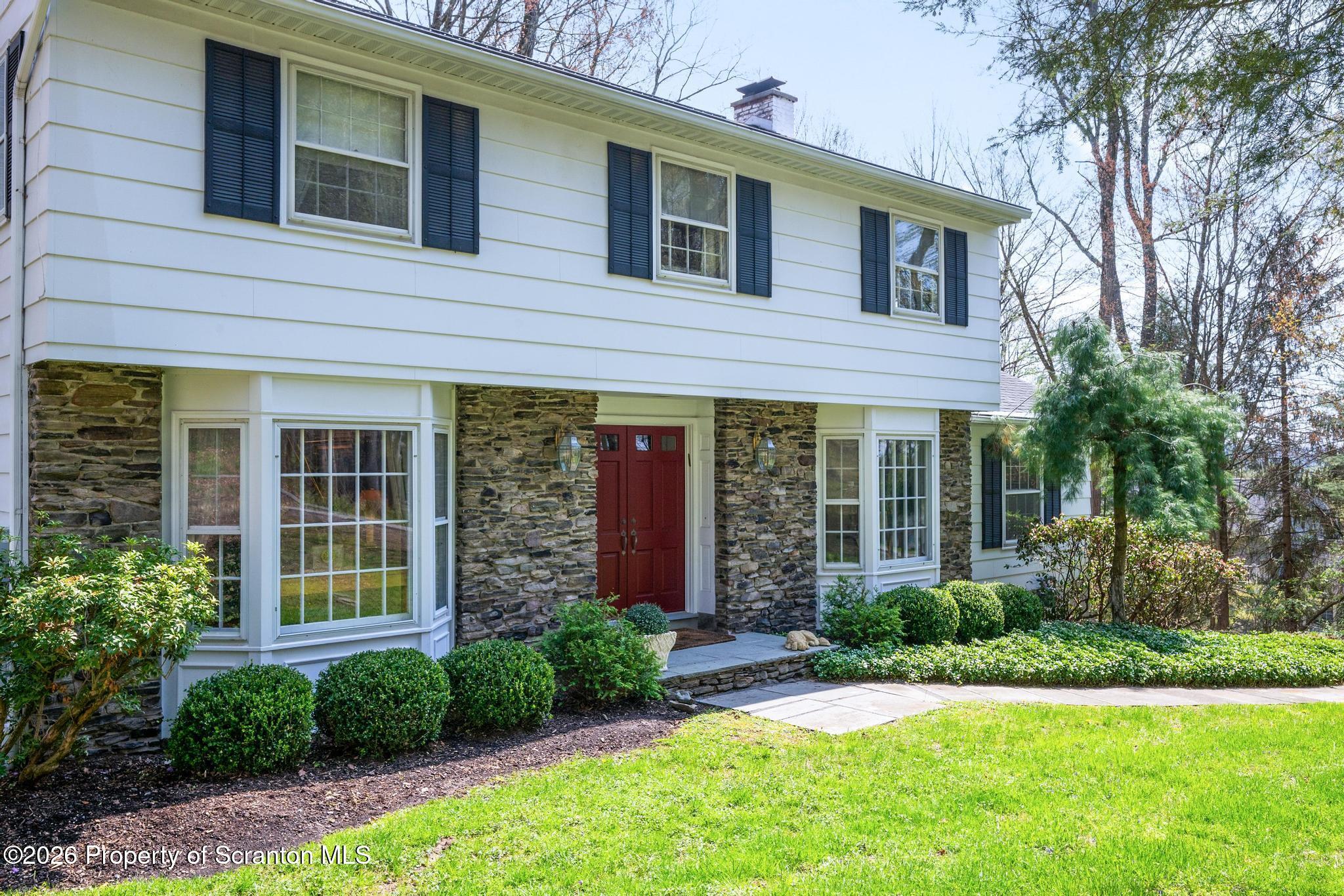 202 Woodlea Road Glenburn, PA 18414 - Photo 25 of 28 a front view of a house with garden and porch