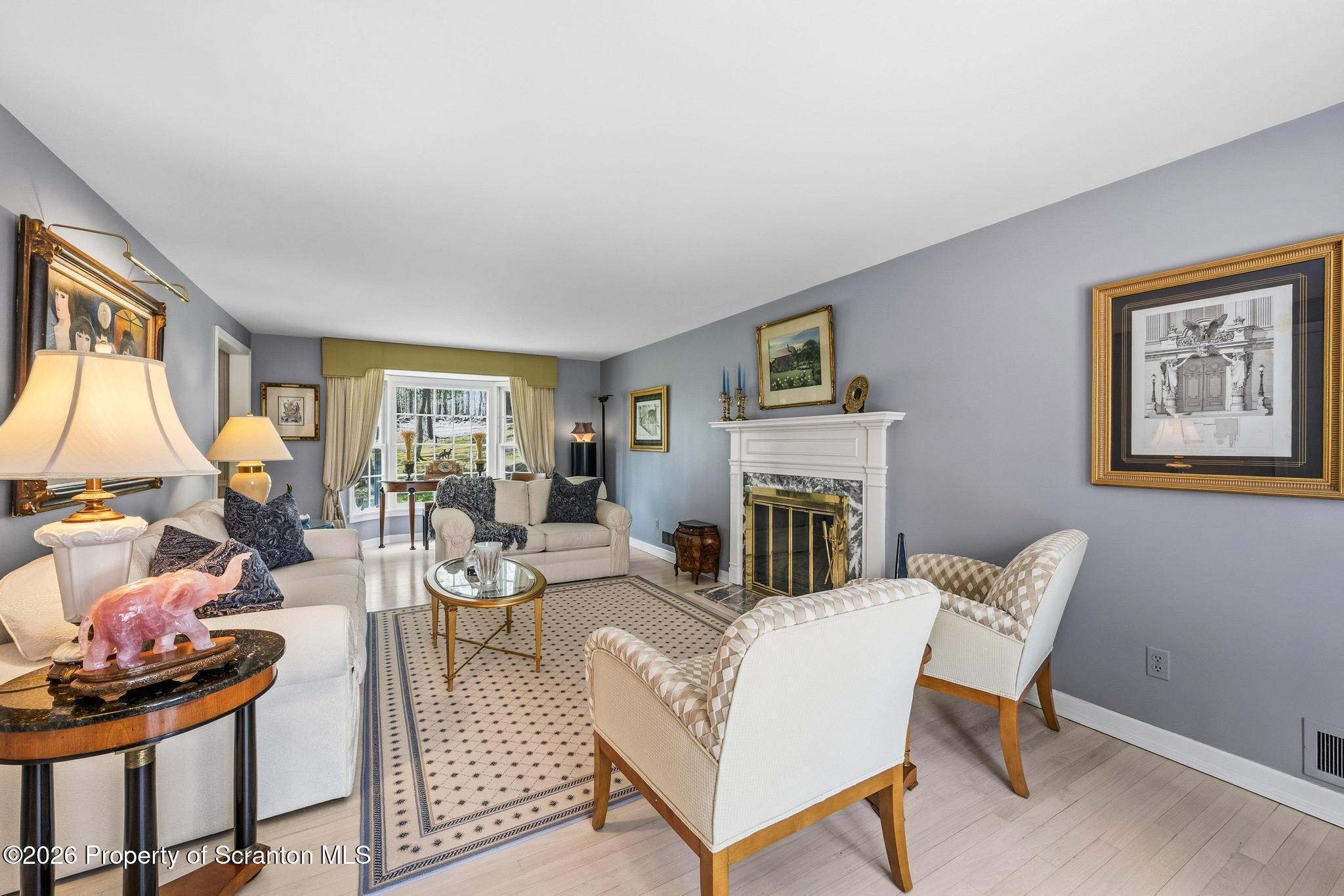 202 Woodlea Road Glenburn, PA 18414 - Photo 6 of 28 a living room with furniture a fireplace and a window