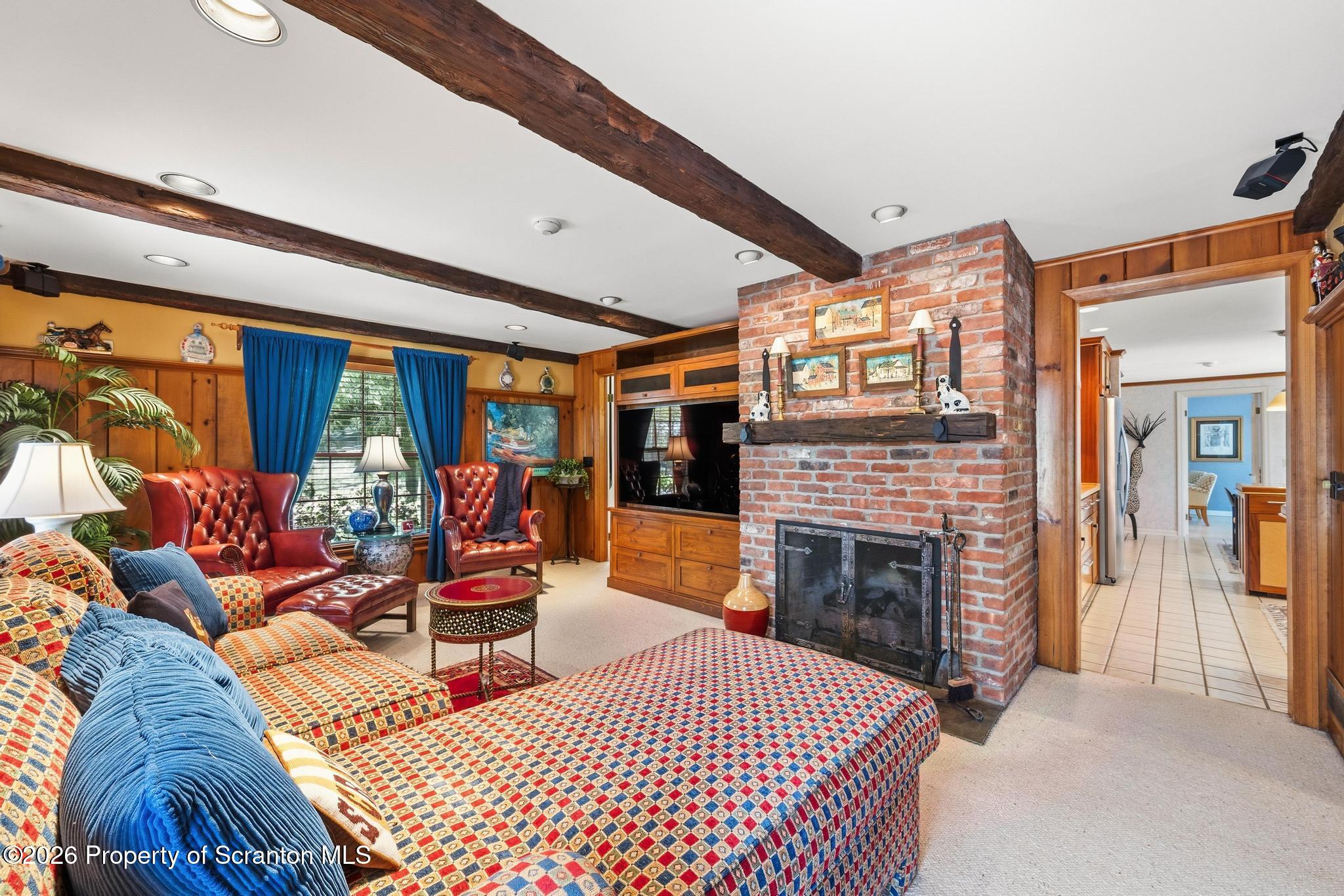 202 Woodlea Road Glenburn, PA 18414 - Photo 7 of 28 a living room with furniture a fireplace and city view