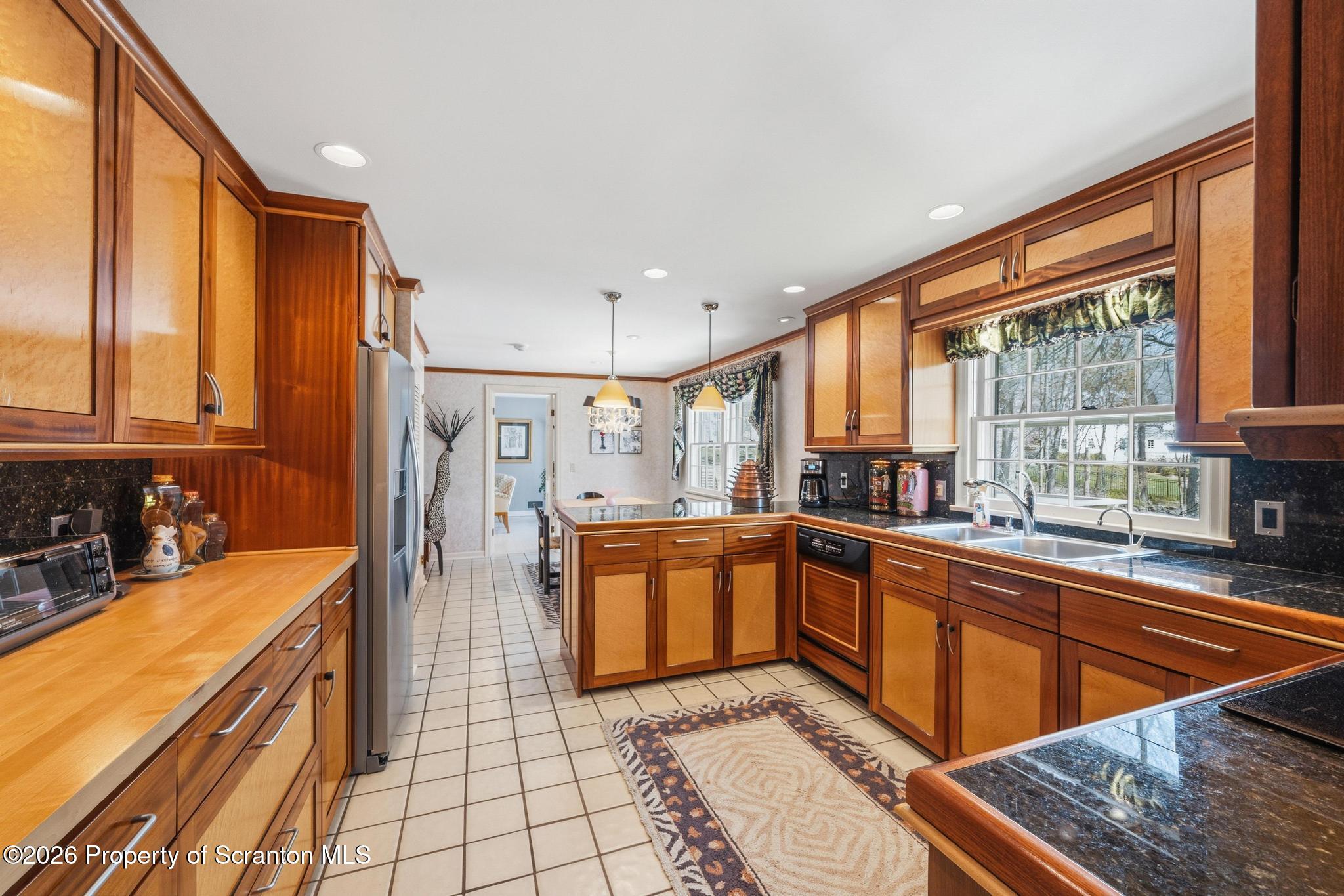 202 Woodlea Road Glenburn, PA 18414 - Photo 10 of 28 a large kitchen with stainless steel appliances granite countertop a sink and cabinets