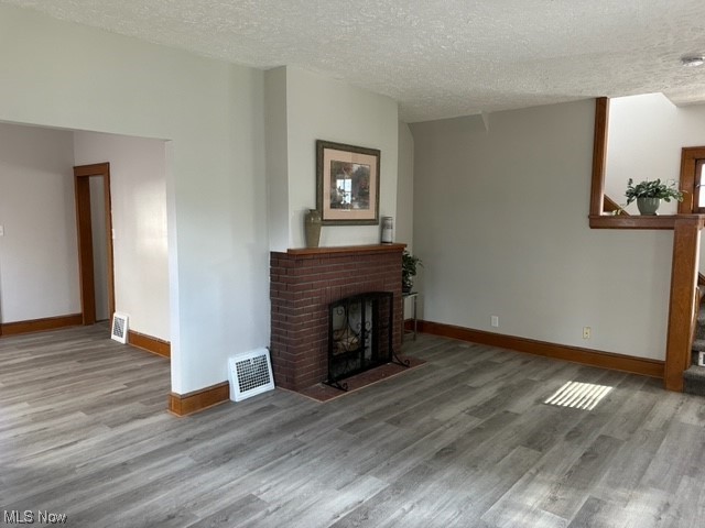 997 Berwin Street Akron, OH 44310 - Photo 9 of 34 Hardwood floored living room with a textured ceiling and a fireplace