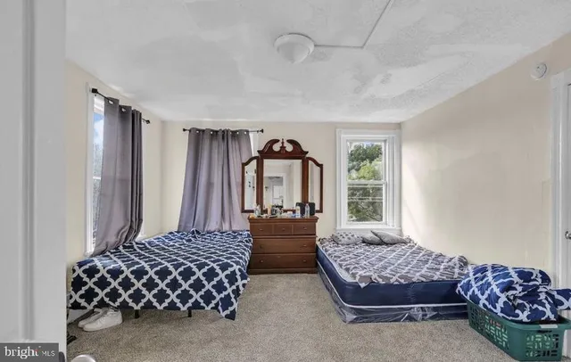 a bedroom with bed and window