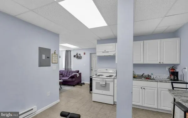 a kitchen with white cabinets and white appliances