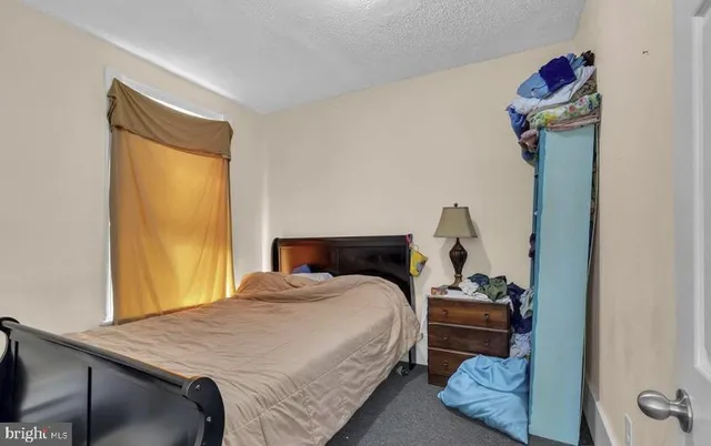 a bedroom with furniture and a mirror