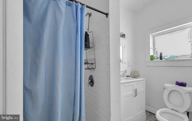 a front view of a house with entryway and wooden floor