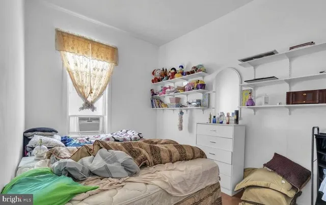 a bedroom with furniture and a window