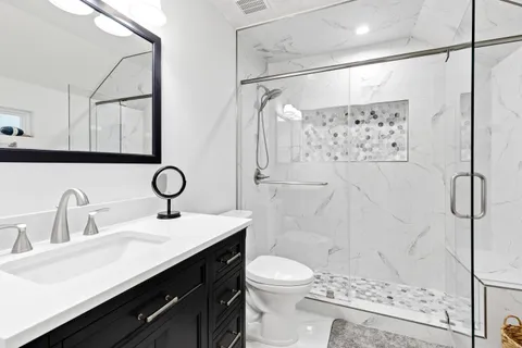 a bathroom with a sink toilet and shower