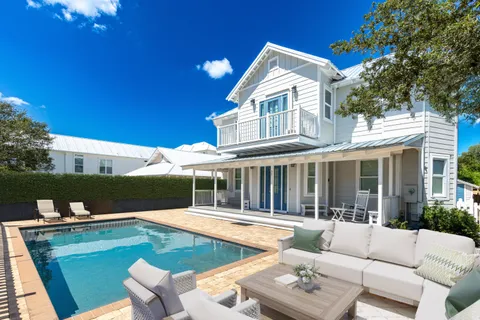 a view of house with swimming pool outdoor seating