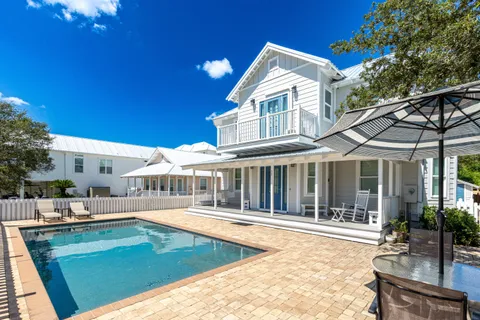 a view of a white building with a swimming pool