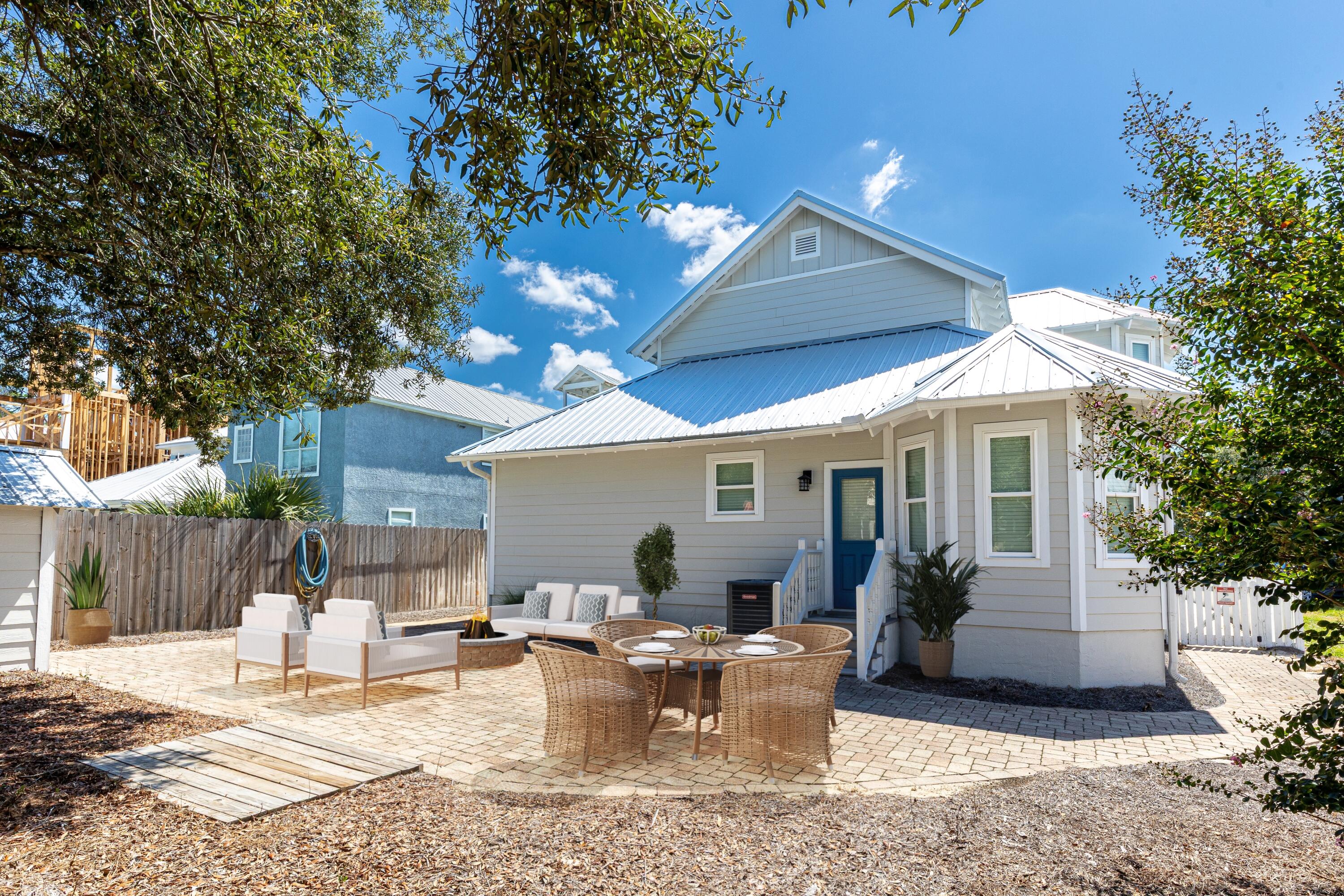 57 Pelayo Avenue Santa Rosa Beach, FL 32459 - Photo 23 of 43 a view of a patio with couches table and chairs and potted plants