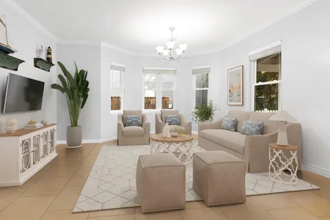 a living room with furniture a large window and a flat screen tv