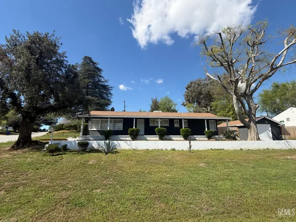 a view of a house with pool and chairs