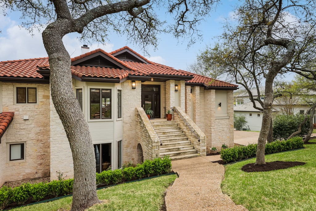 a front view of a house with a garden