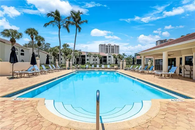 a swimming pool with outdoor seating