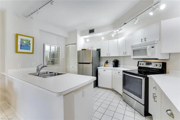 a kitchen with stainless steel appliances granite countertop a sink and cabinets