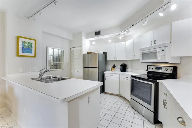 a kitchen with stainless steel appliances granite countertop a sink and cabinets