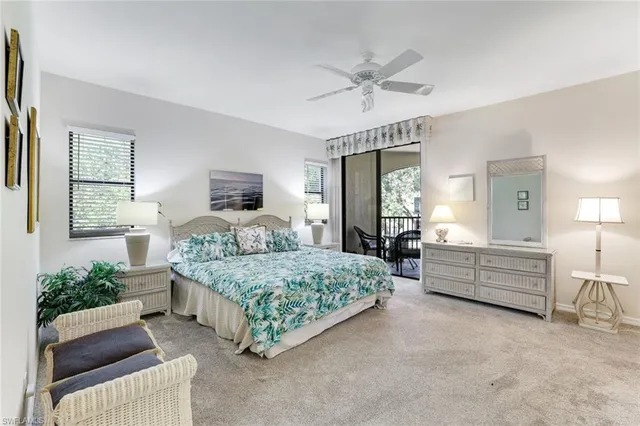 a large white bathroom with a tub sink shower and mirror