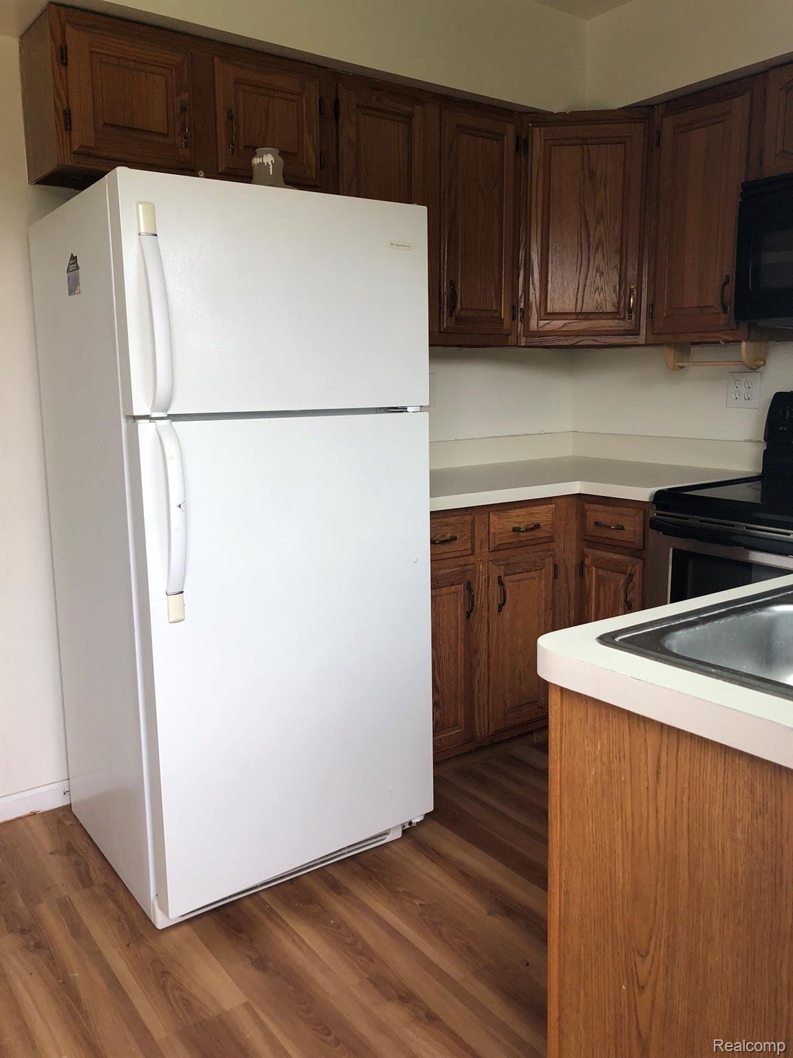 11562 North Fowlerville Road Fowlerville, MI 48836 - Photo 12 of 19 Kitchens include refrigerator, stove, and microwave