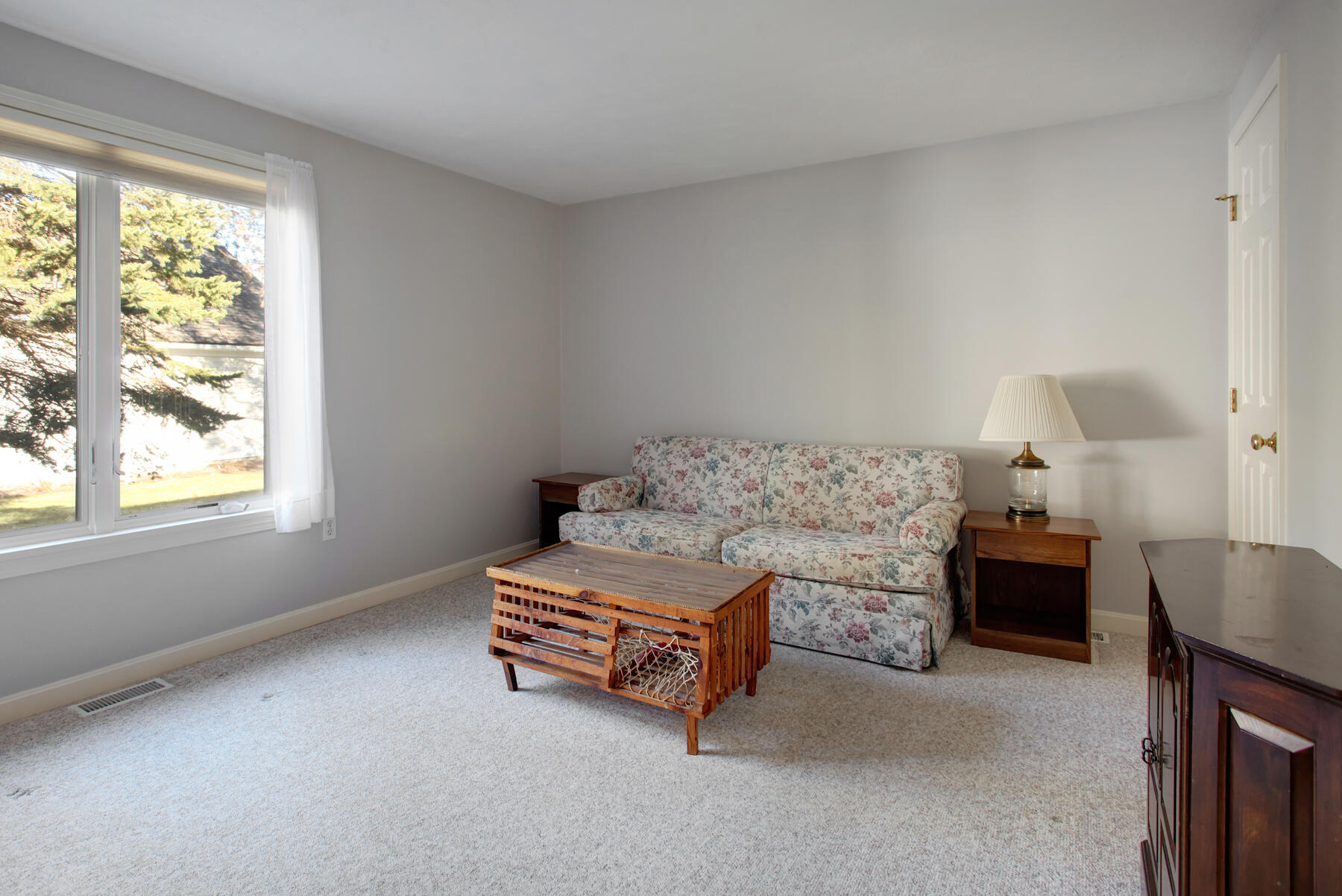 18 Executive Drive Mashpee, MA 02649 - Photo 13 of 22 a room with a bed and a lamp on table