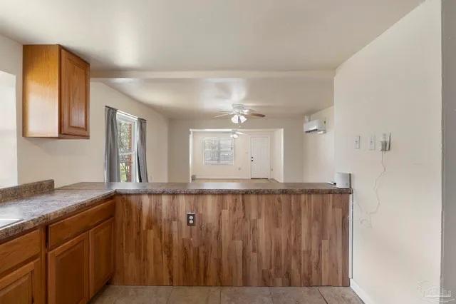 a view of a kitchen with wooden floor and window