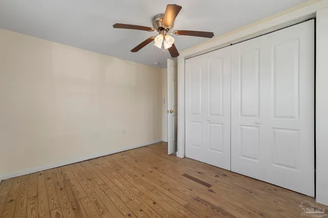 a view of room with hardwood floor and ceiling fan