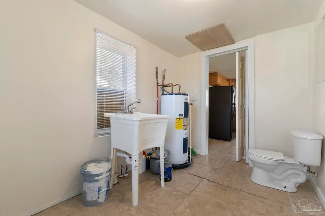 a white toilet sitting next to a bathroom sink