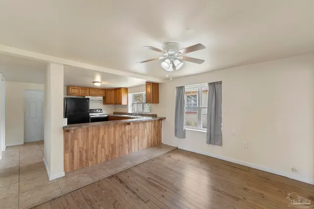 a kitchen with stainless steel appliances a refrigerator and a stove top oven