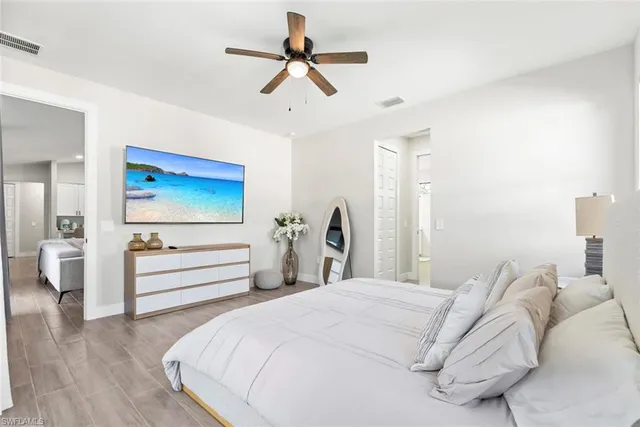 a bedroom with a bed and a chandelier