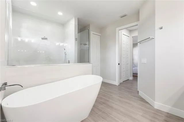 a bathroom with a bathtub and a shower