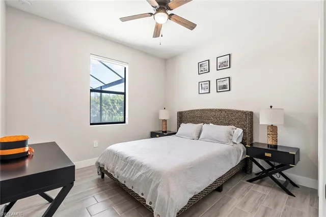 a bedroom with a bed a table and chair